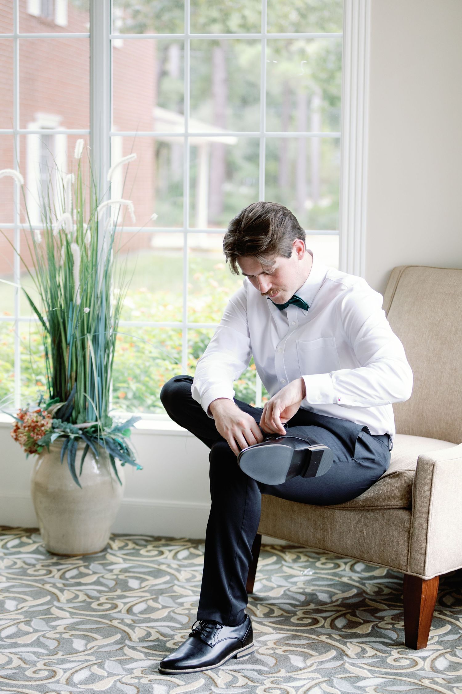 A series of photos showing a person in formal attire getting ready while sitting on a beige couch near decorative plants.