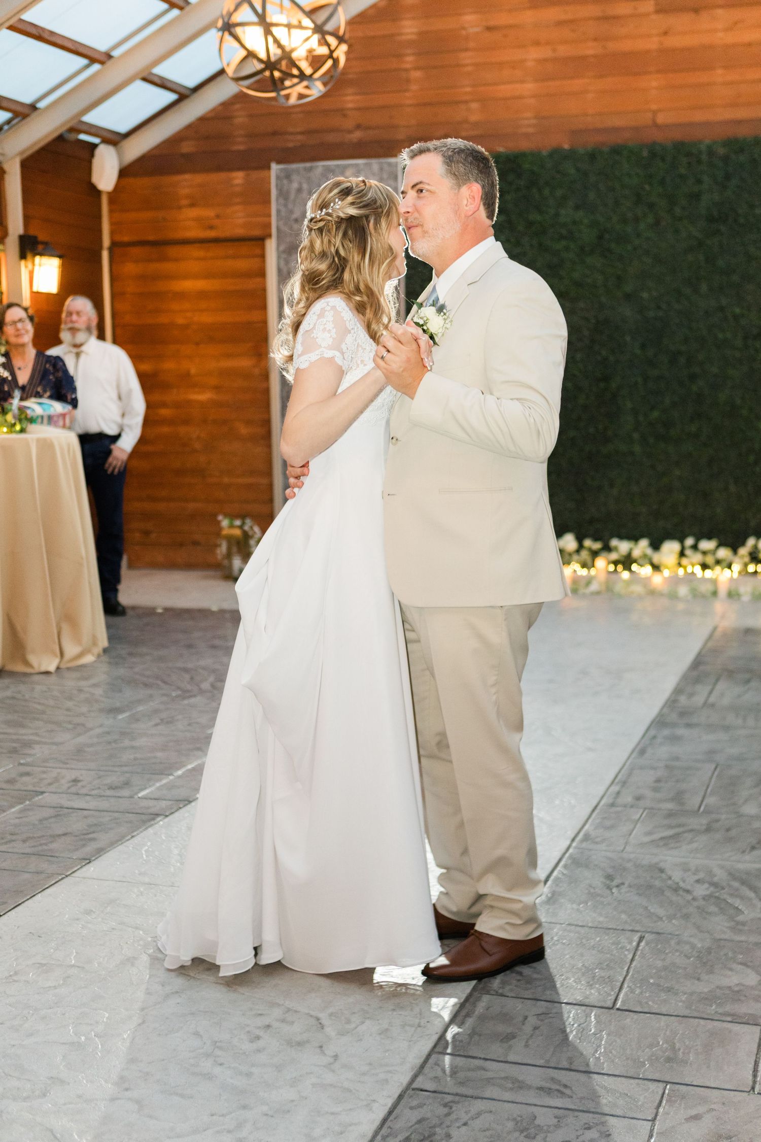 Wedding dance sequence showing graceful movements on a stone floor under wooden beams.