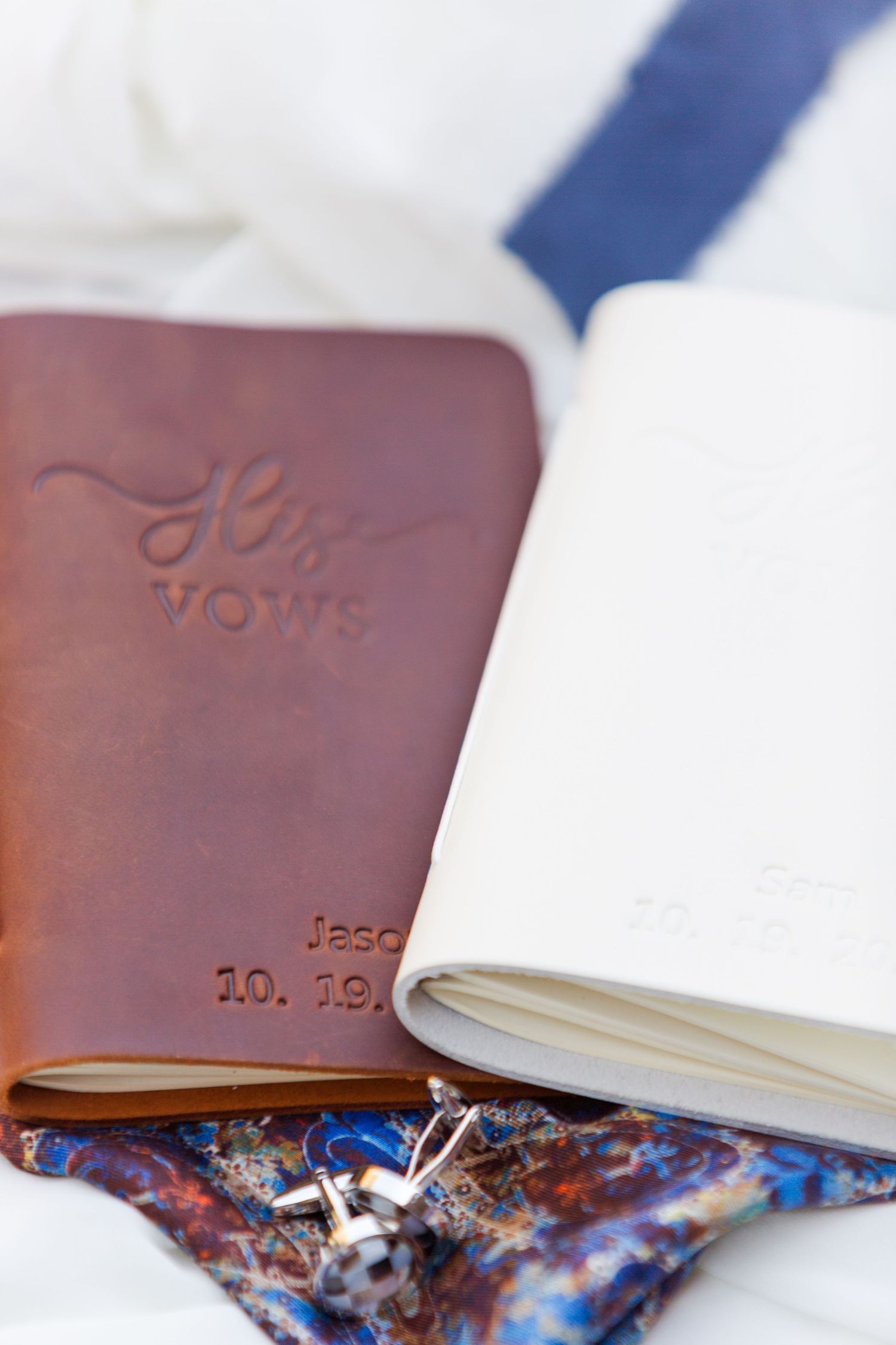 Brown leather journals or albums with decorative fabric accents.