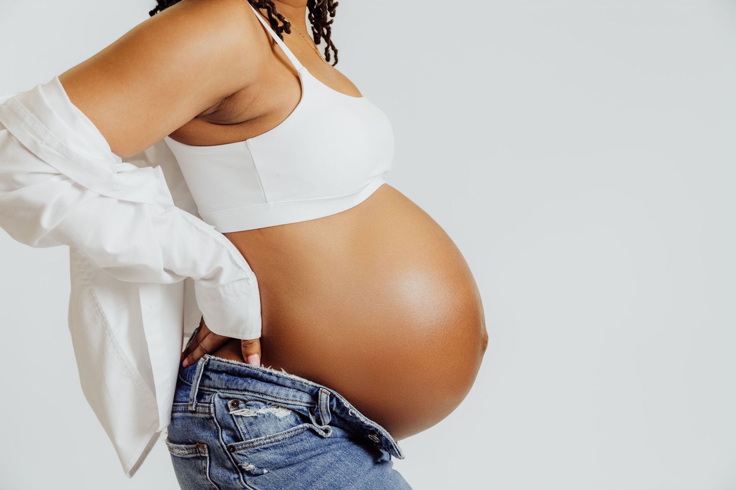 Faceless maternity portrait showcasing side profile of pregnant belly for photoshoot with Tami Harris Photography in Worthington OH studio