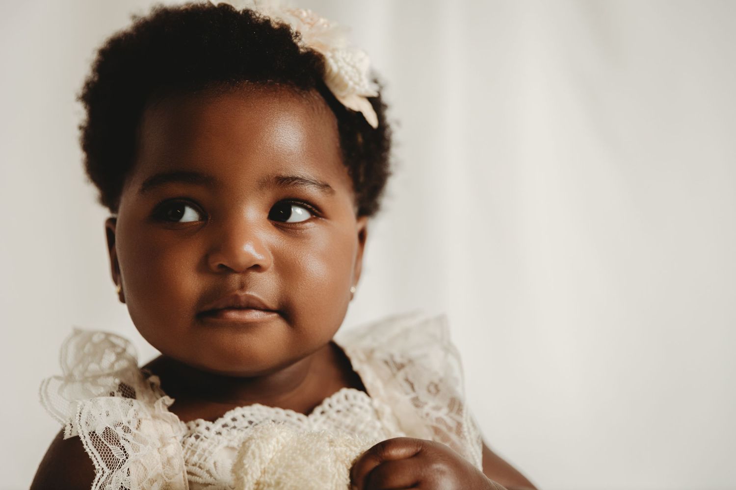 Baby girl giving side-eye while in-studio for 1st birthday photos photoshoot with Tami Harris Photography in Columbus Ohio area
