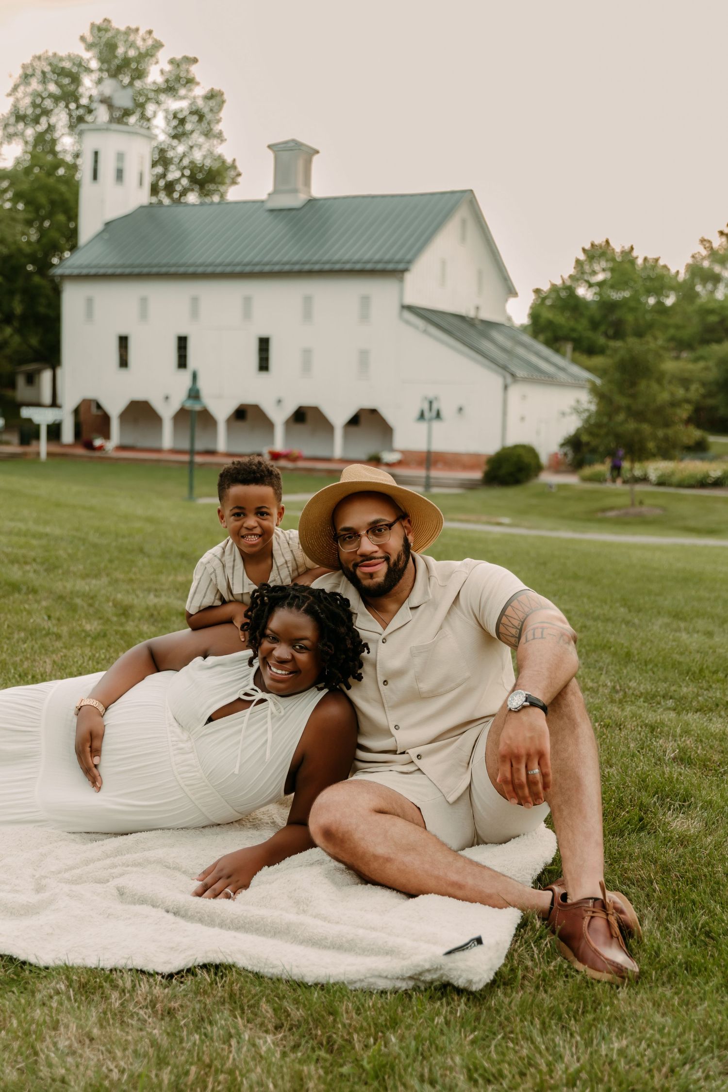 Mother-to-be poses with husband and son during Maternity portraits with Tami Harris Photography at the Everal Barn in Westerville, OH