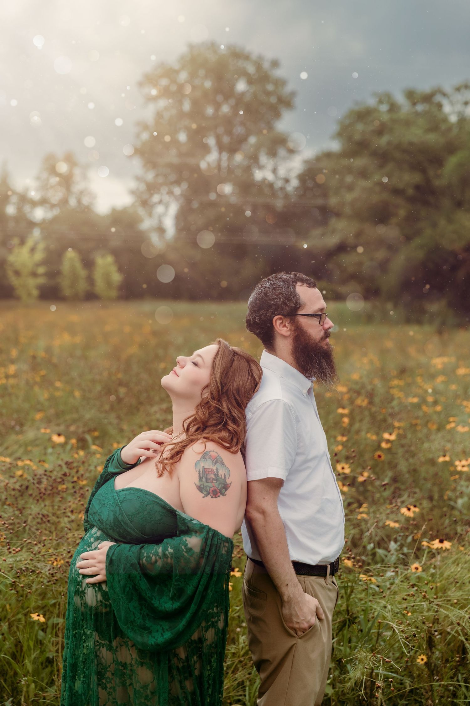 Pregnant mother-to-be rests head on her partner in a field of wildflowers during outdoor Maternity photoshoot with Tami Harris Photography
