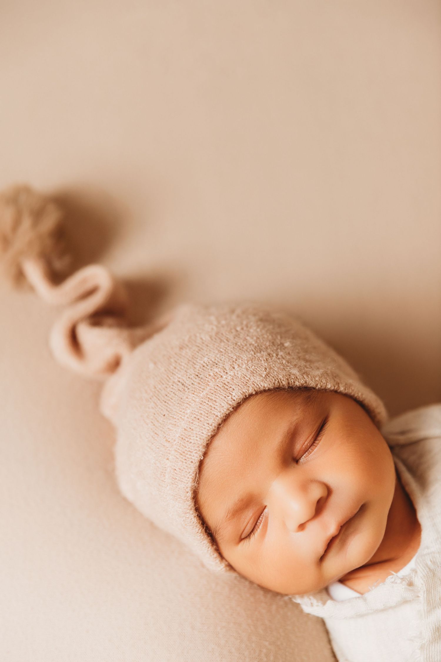 Newborn boy sleeping with sleepy cap hat on during photoshoot with Tami Harris Photography in central Ohio studio
