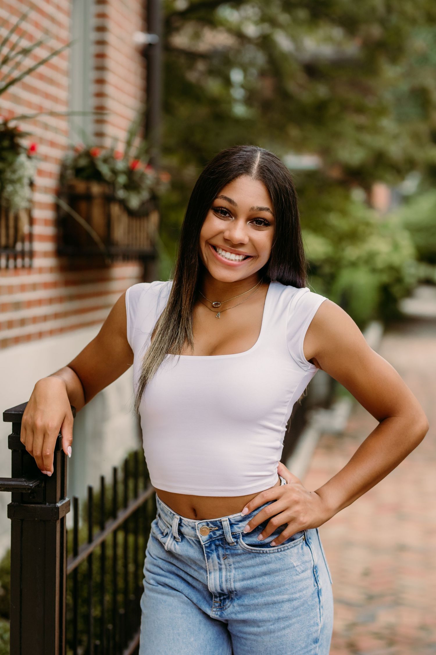 Senior portrait of girl resting arm on a fence in German Village in Columbus OH during photoshoot with Tami Harris Photography