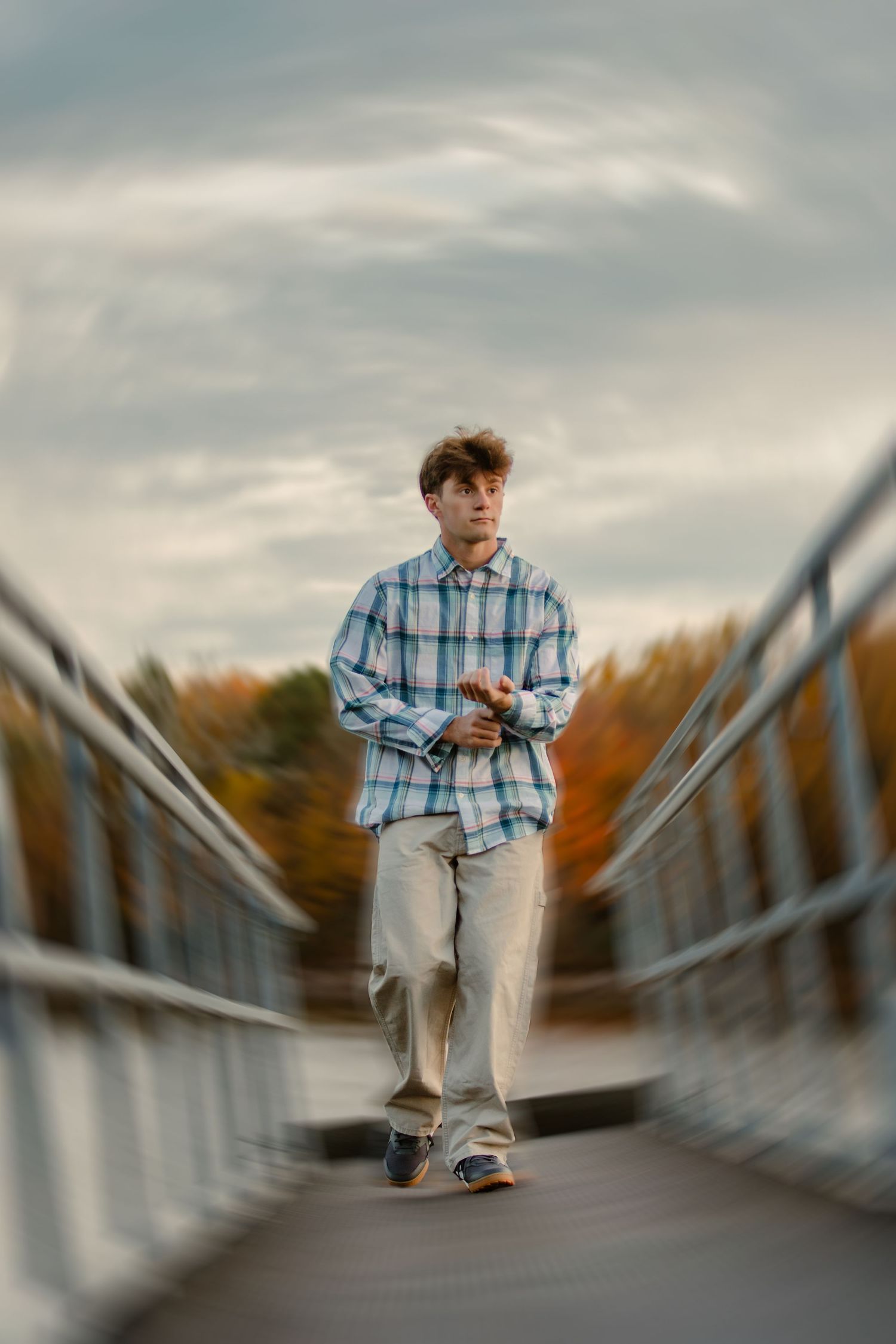 High school senior photography session with male walking on bridge at Alum Creek in Westerville, Galena, Ohio.