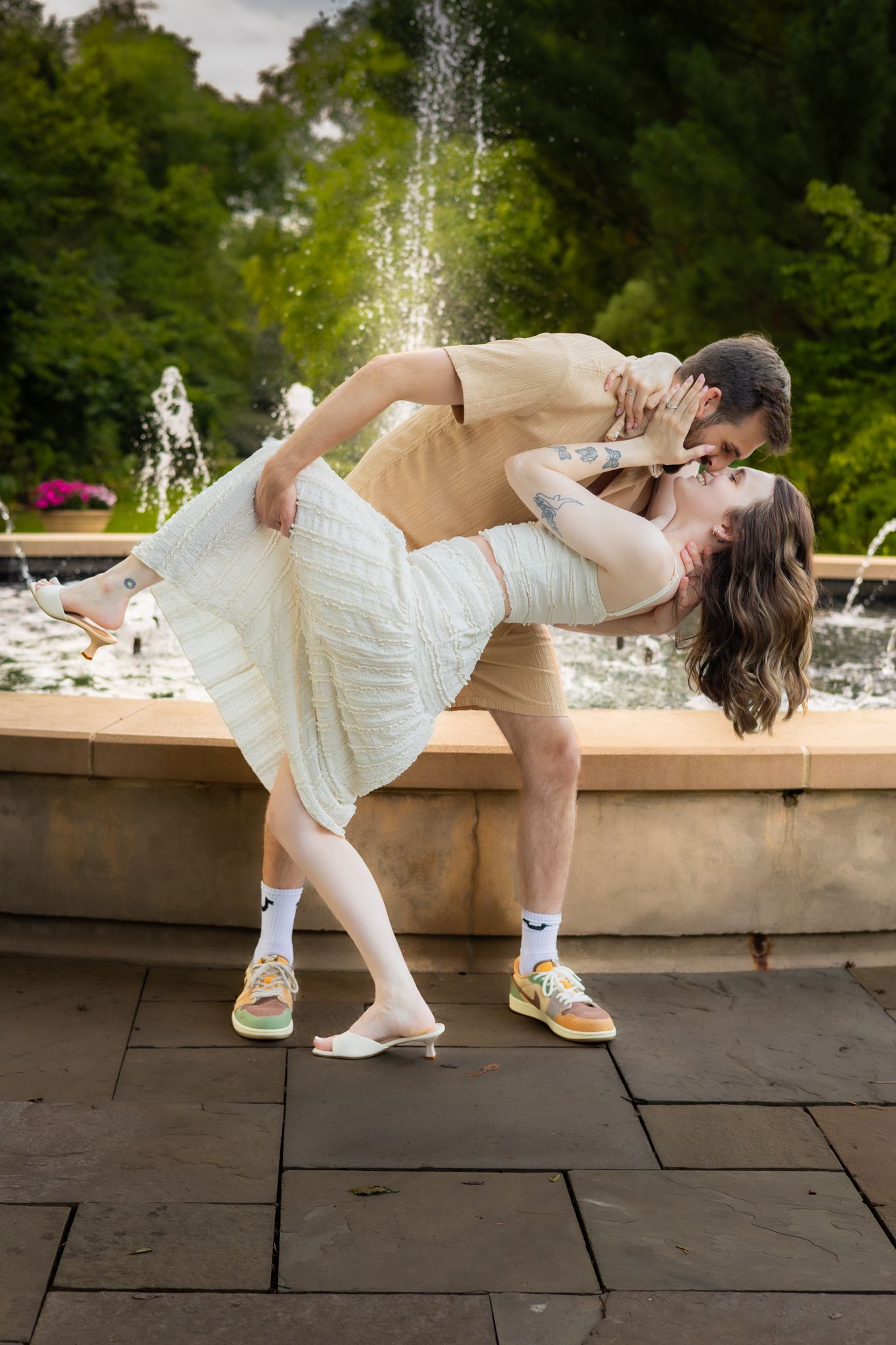 Row of romantic wedding photos showing couple dipping while standing near fountain on stone patio in outdoor setting in Youngstown, Ohio.