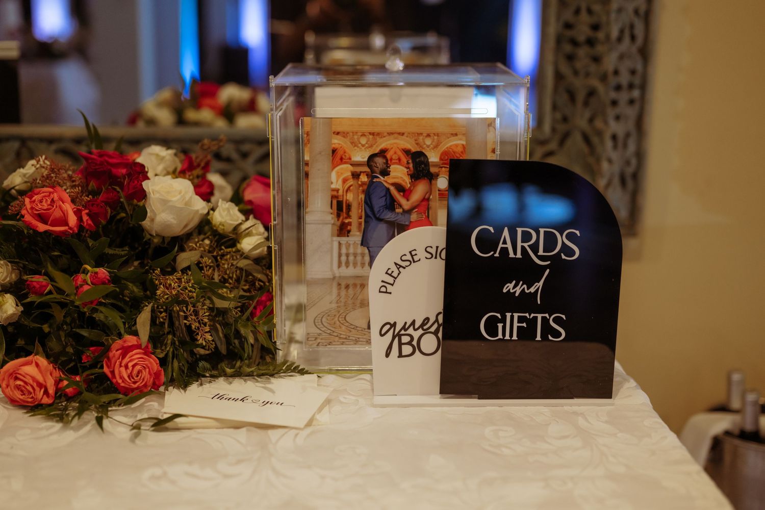Wedding reception gift and card table with decorative floral arrangements.