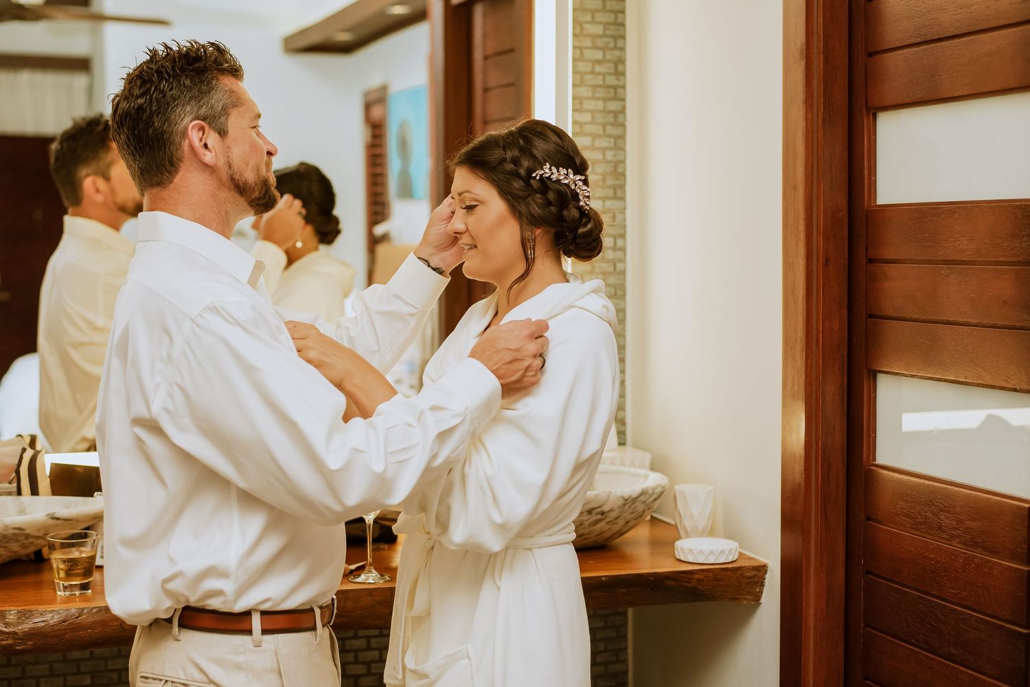 Wedding morning preparations showing intimate moments in a sunlit room.