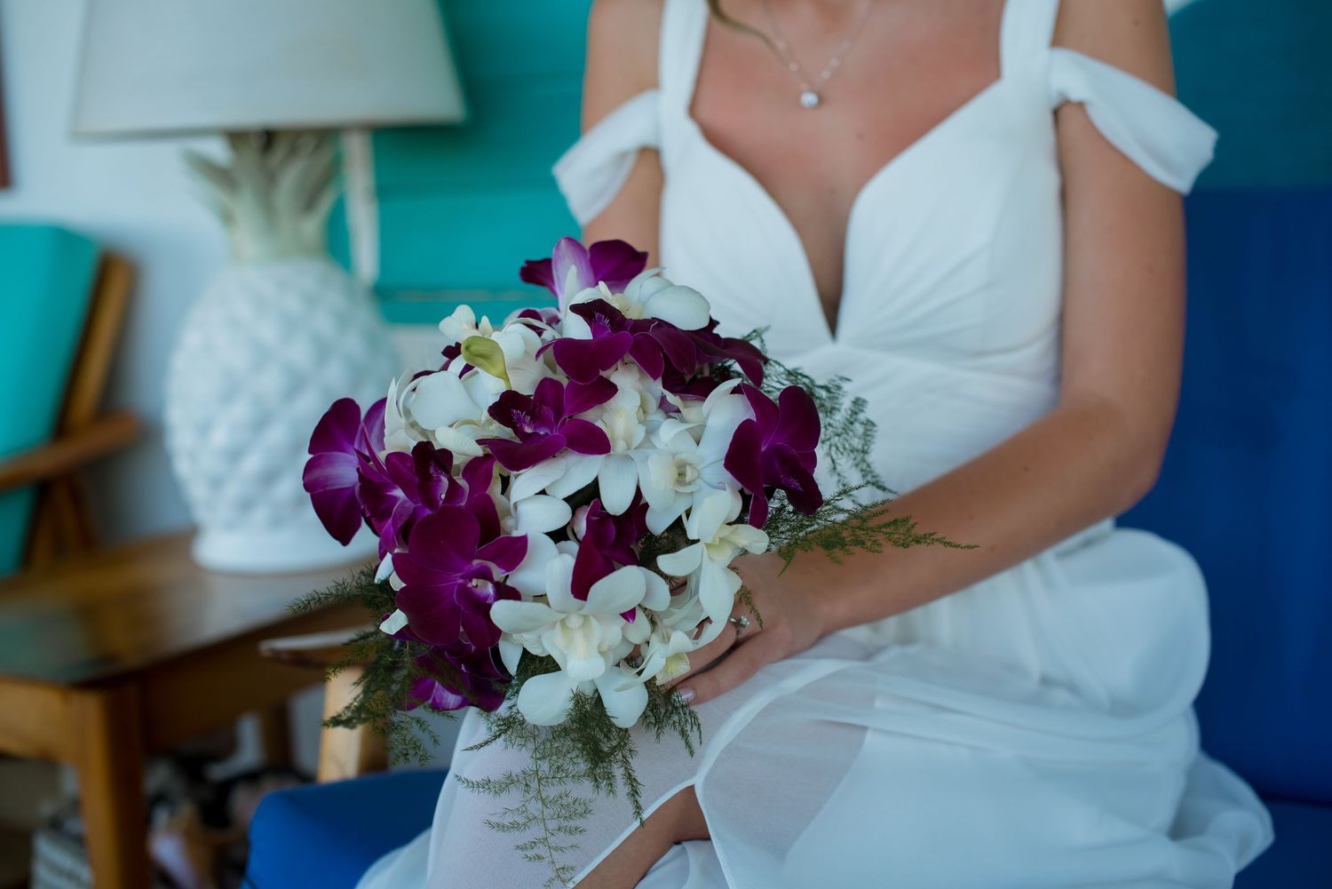 A white wedding dress and purple orchid bouquet are displayed in a series of detail shots.