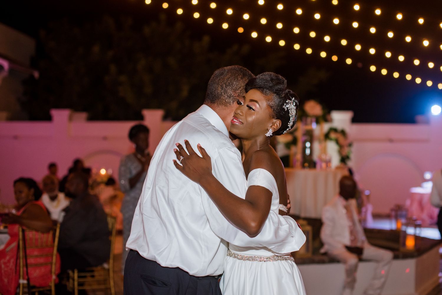 Wedding reception dance floor with string lights creating a romantic atmosphere.