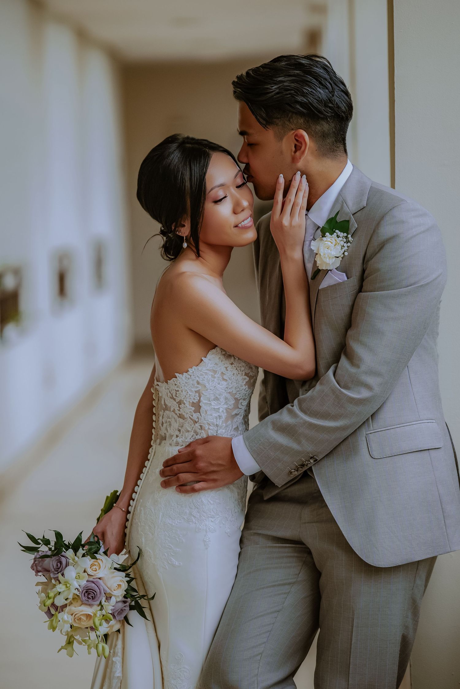Romantic wedding portraits in muted tones showing tender moments between newlyweds.