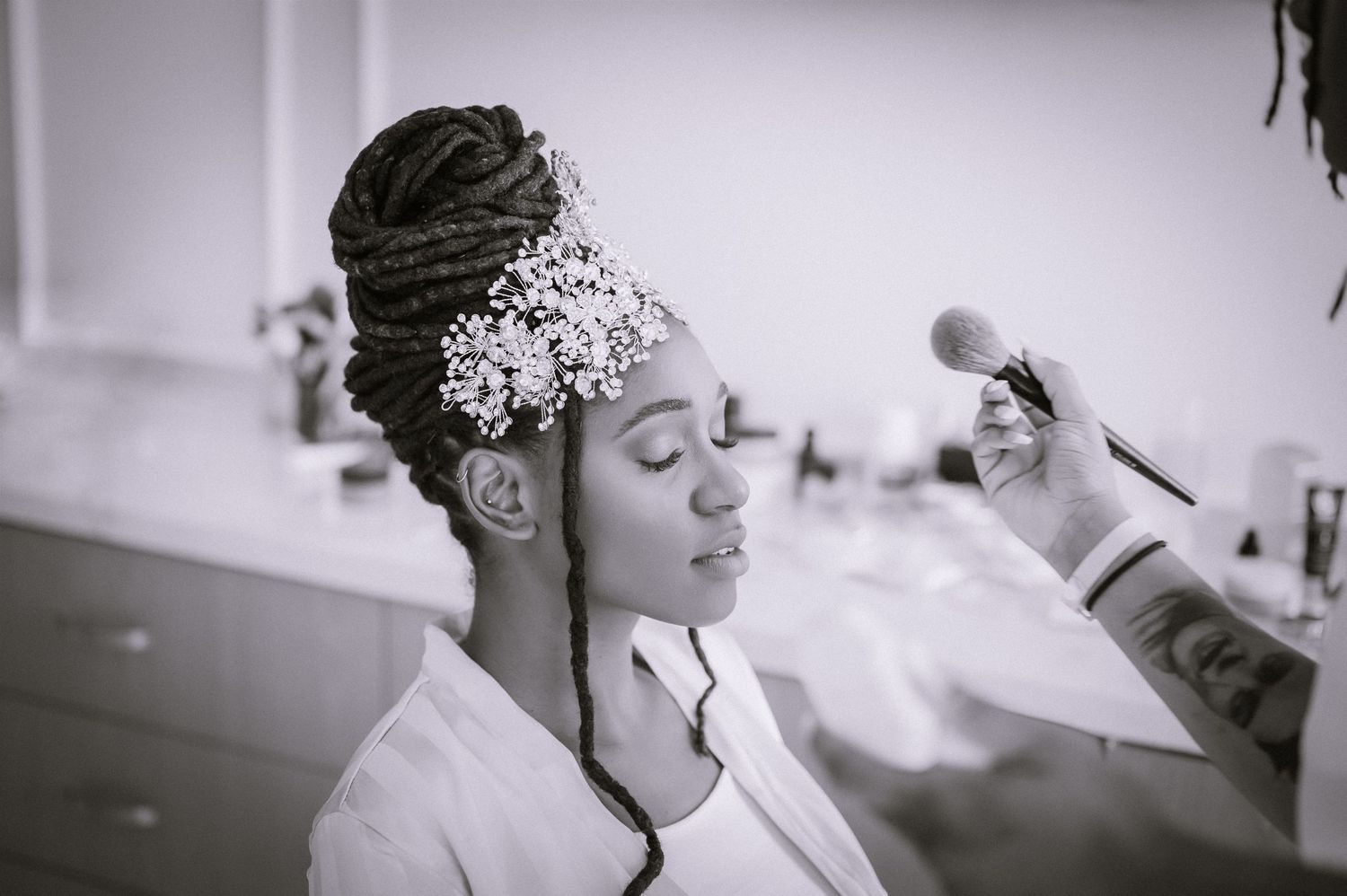 Black and white getting ready photos showing wedding preparation moments.