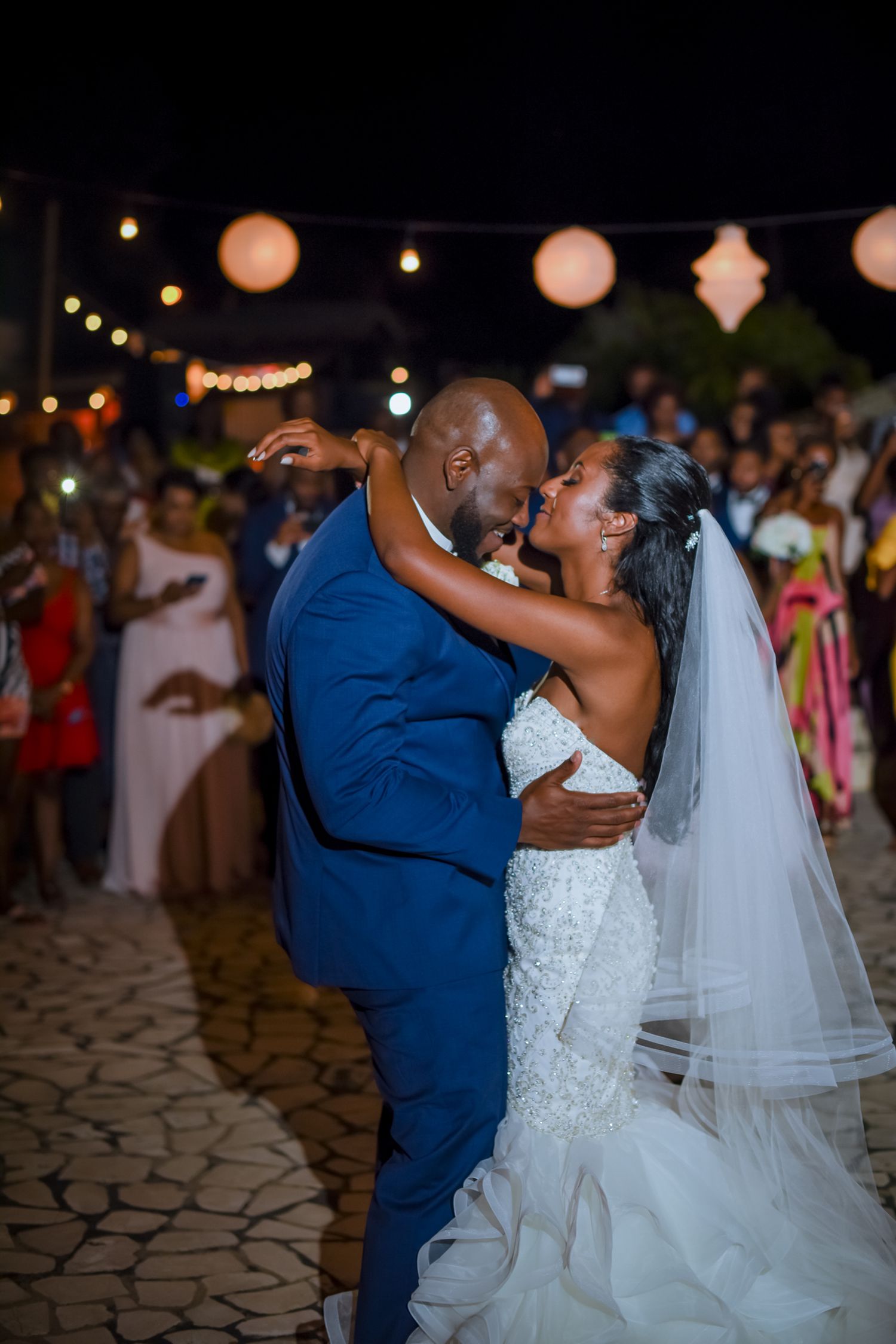 Joyful wedding dance moment captured during an outdoor evening celebration.