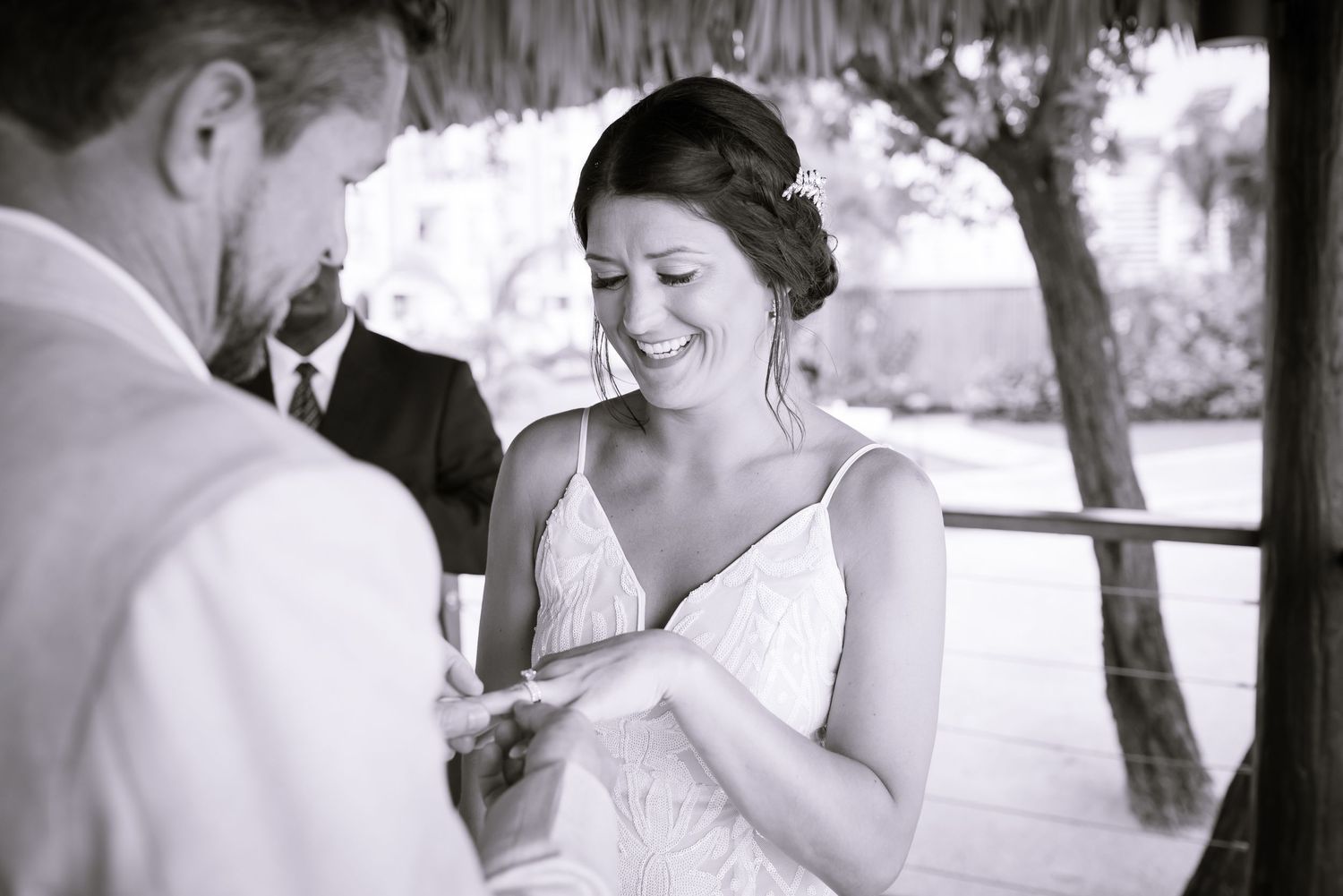 Black and white wedding photos capturing emotional moments during a beach ceremony.