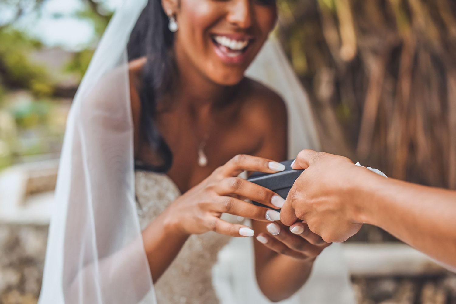 Bride reacts emotionally while reading messages on her wedding day.