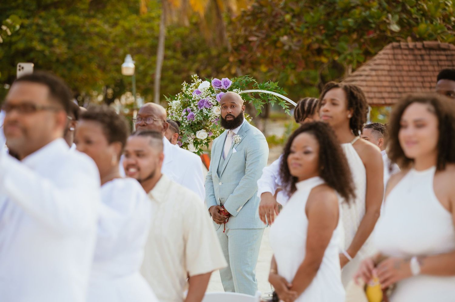 Wedding guests and party members enjoying outdoor celebration in formal attire.