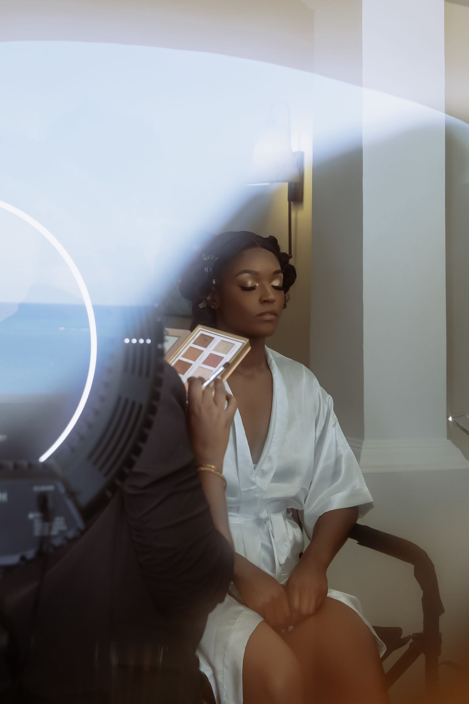 A series of artistic boudoir photos showing someone in a white shirt posing against a light wall.