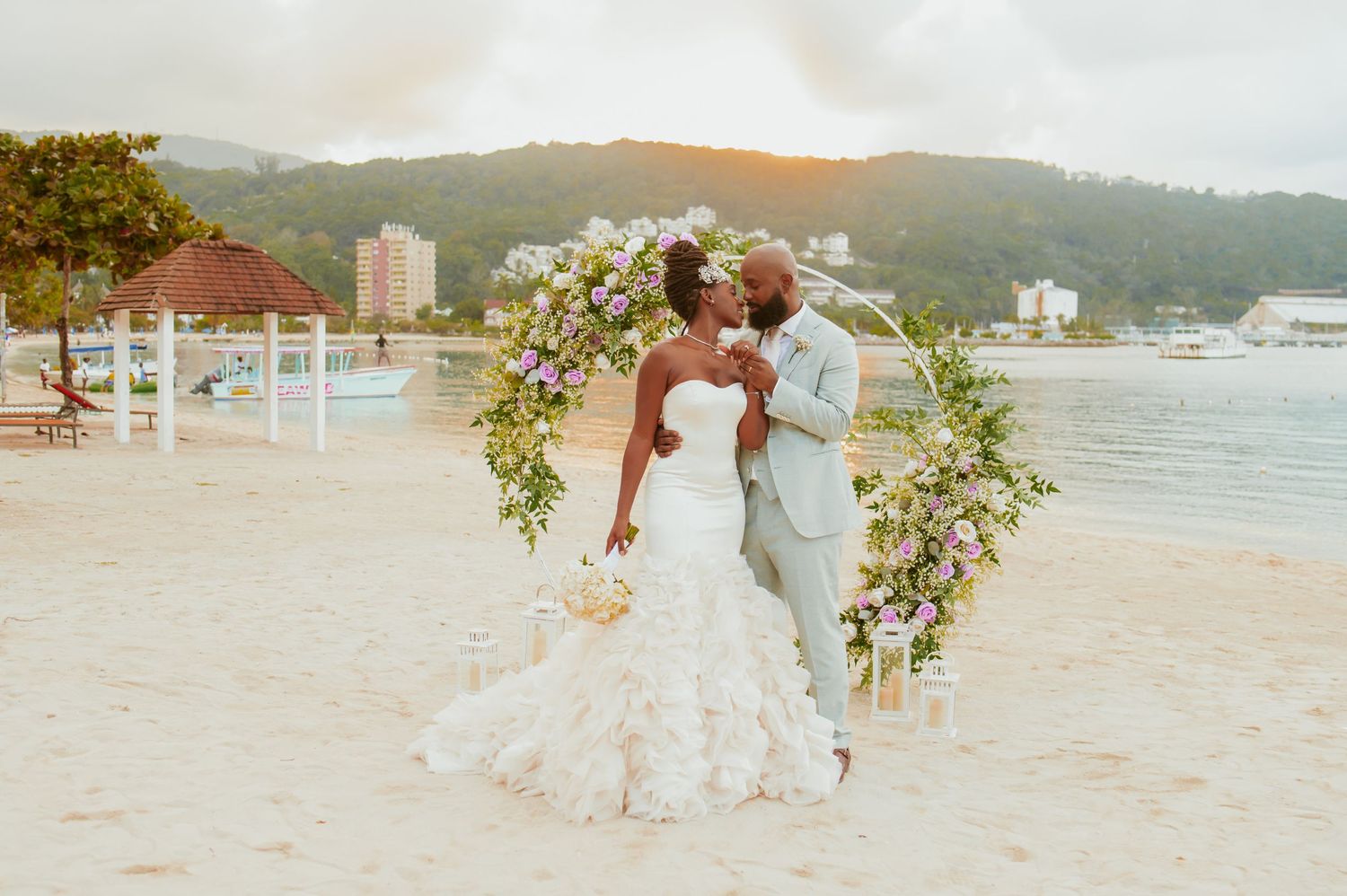 Scenic beach wedding setup with mountains and ocean in the background.
