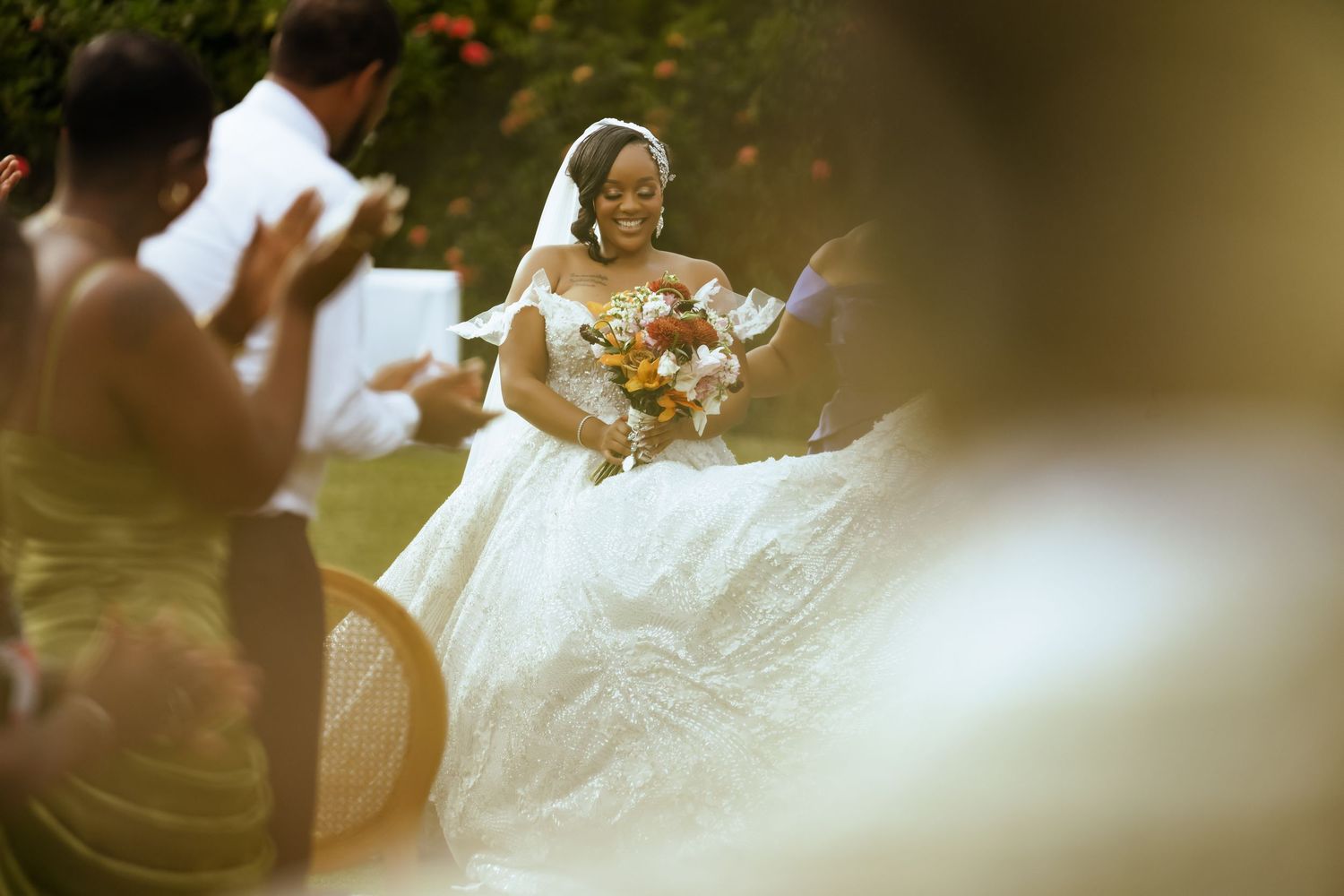 Outdoor wedding ceremony scene with soft focus and natural lighting.