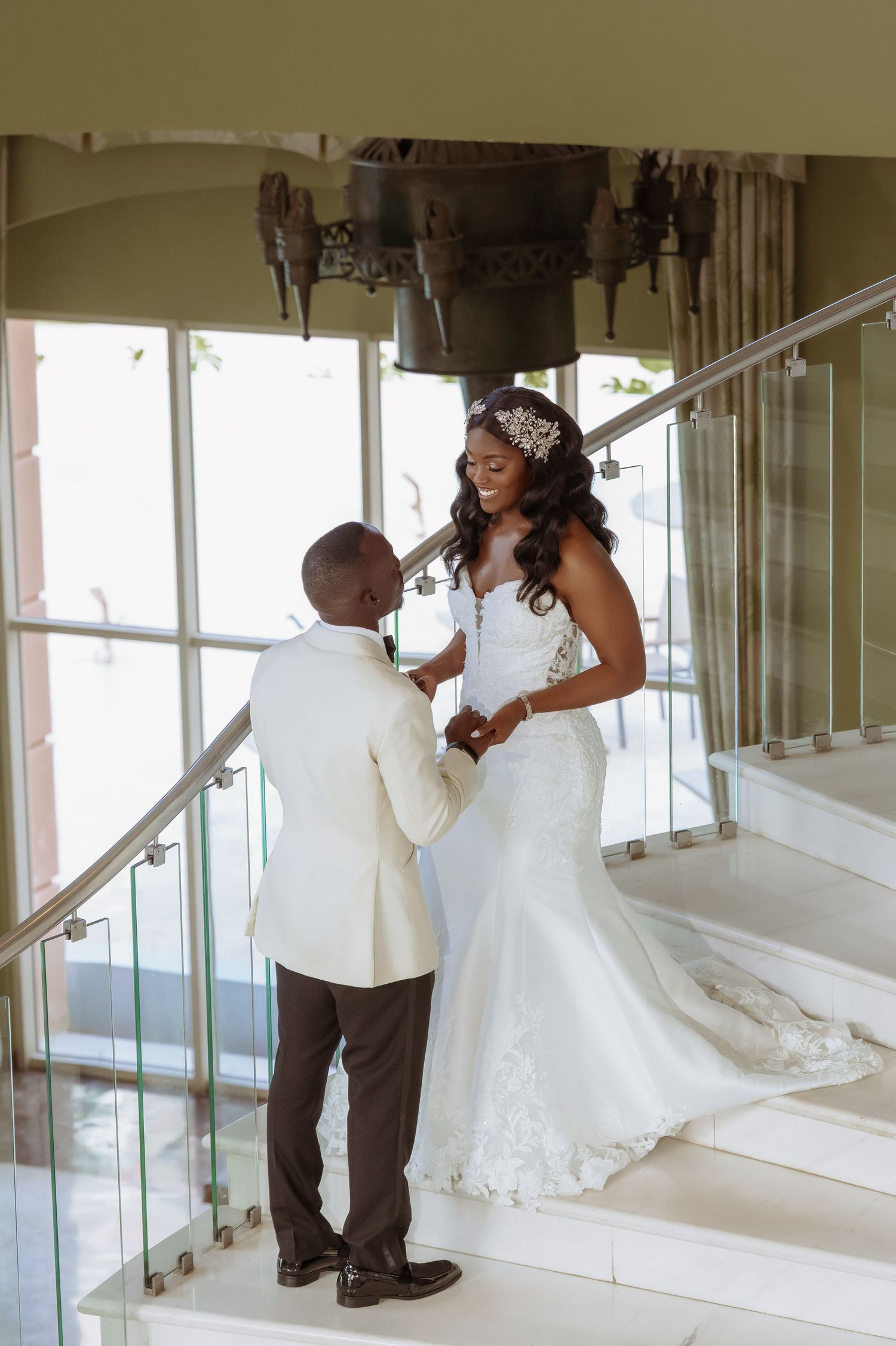 Romantic wedding couple sharing a tender moment in an elegant indoor setting.