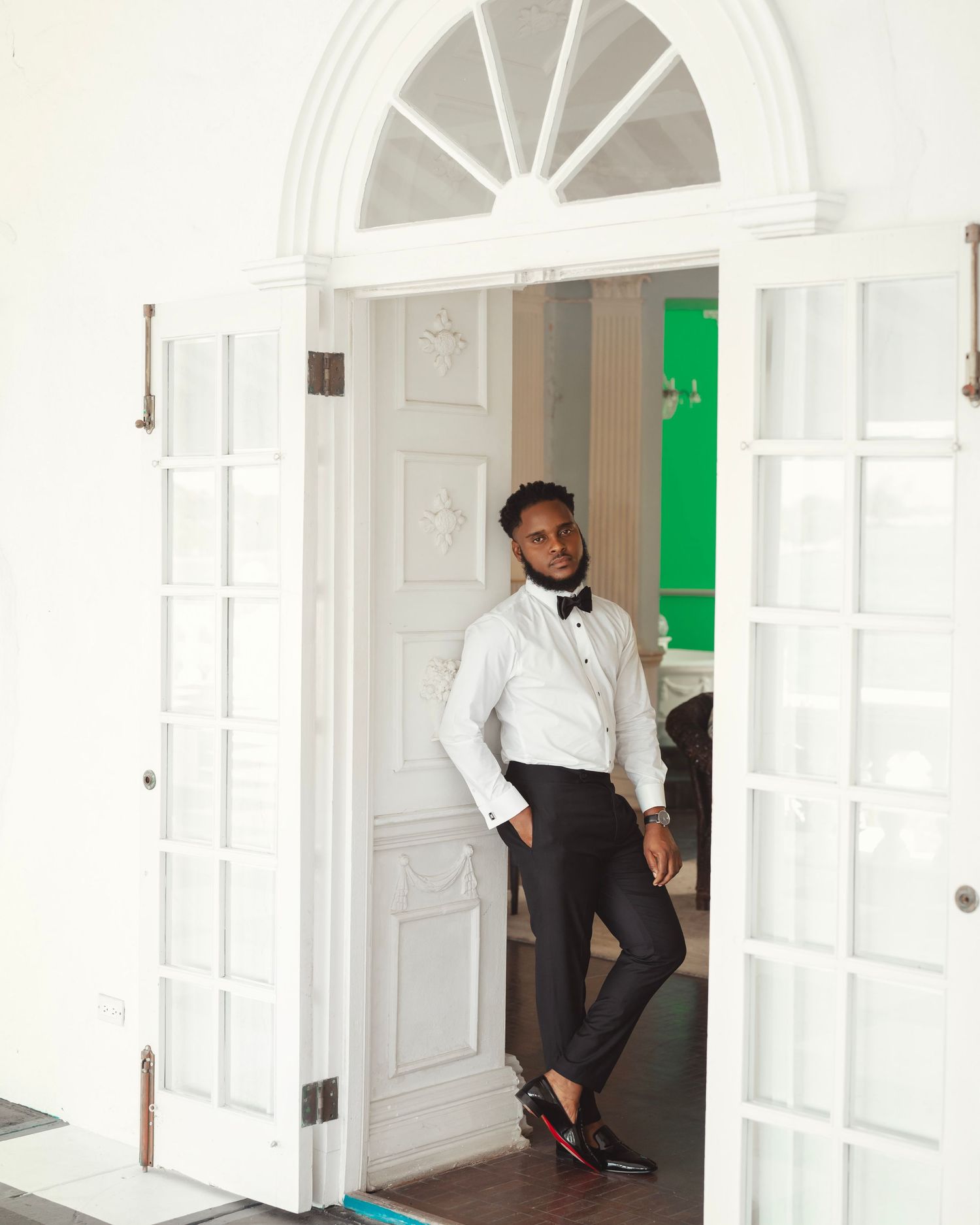 Classic white interior with arched doorways showcases elegant wedding day preparations.