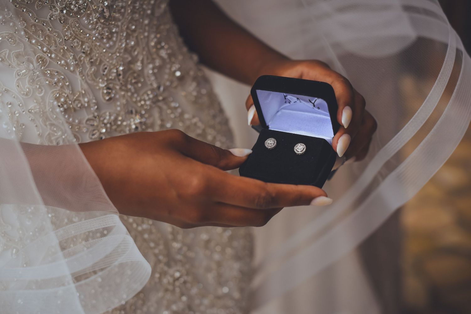 Close-up shot of bride's hands holding a phone during wedding preparations.