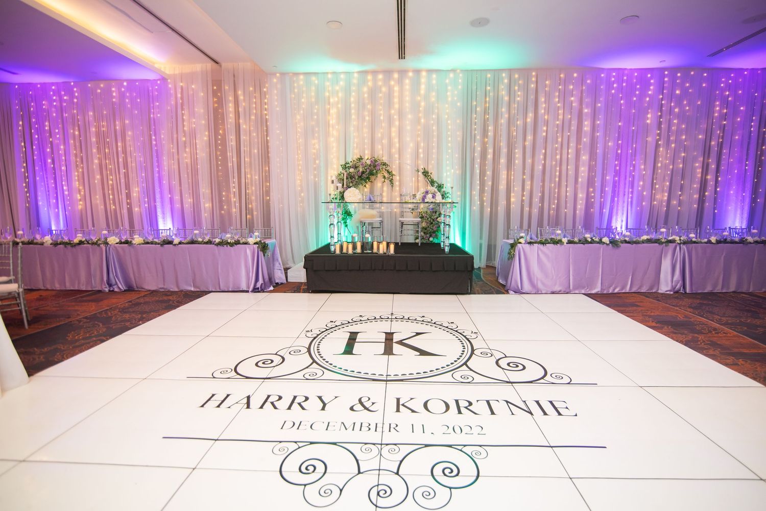 Wedding venue floor featuring personalized monogram design and ambient lighting.