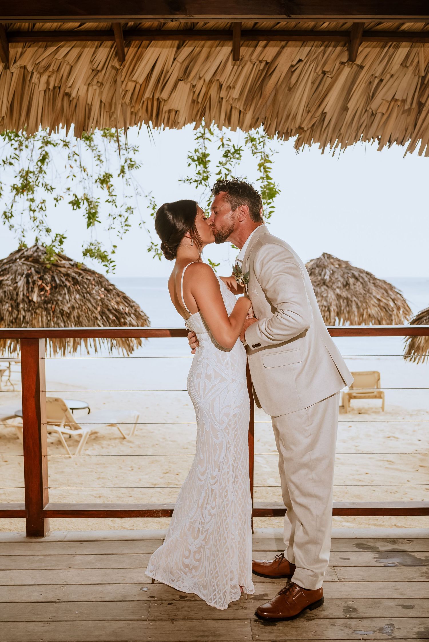 Romantic wedding dance sequence on a wooden deck overlooking the ocean.