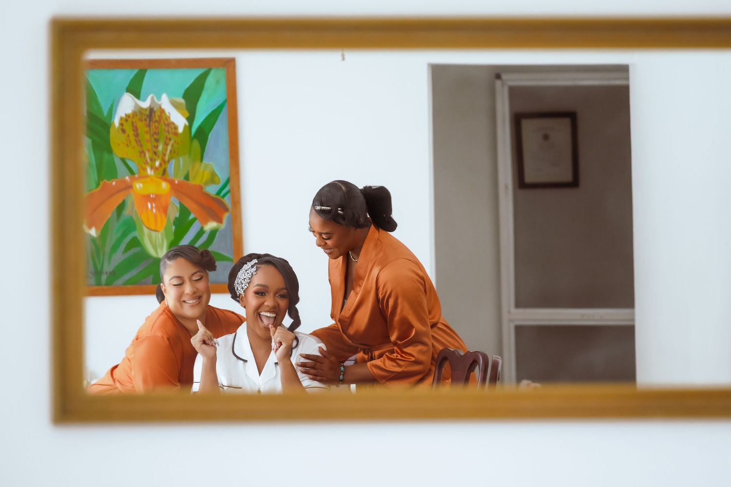 Healthcare workers in white uniforms assist elderly residents at a nursing home with colorful artwork on the walls.