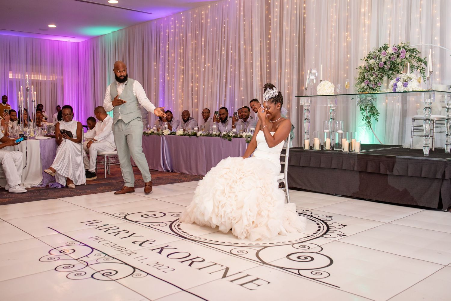 Couple performs special dance on custom monogrammed reception dance floor.