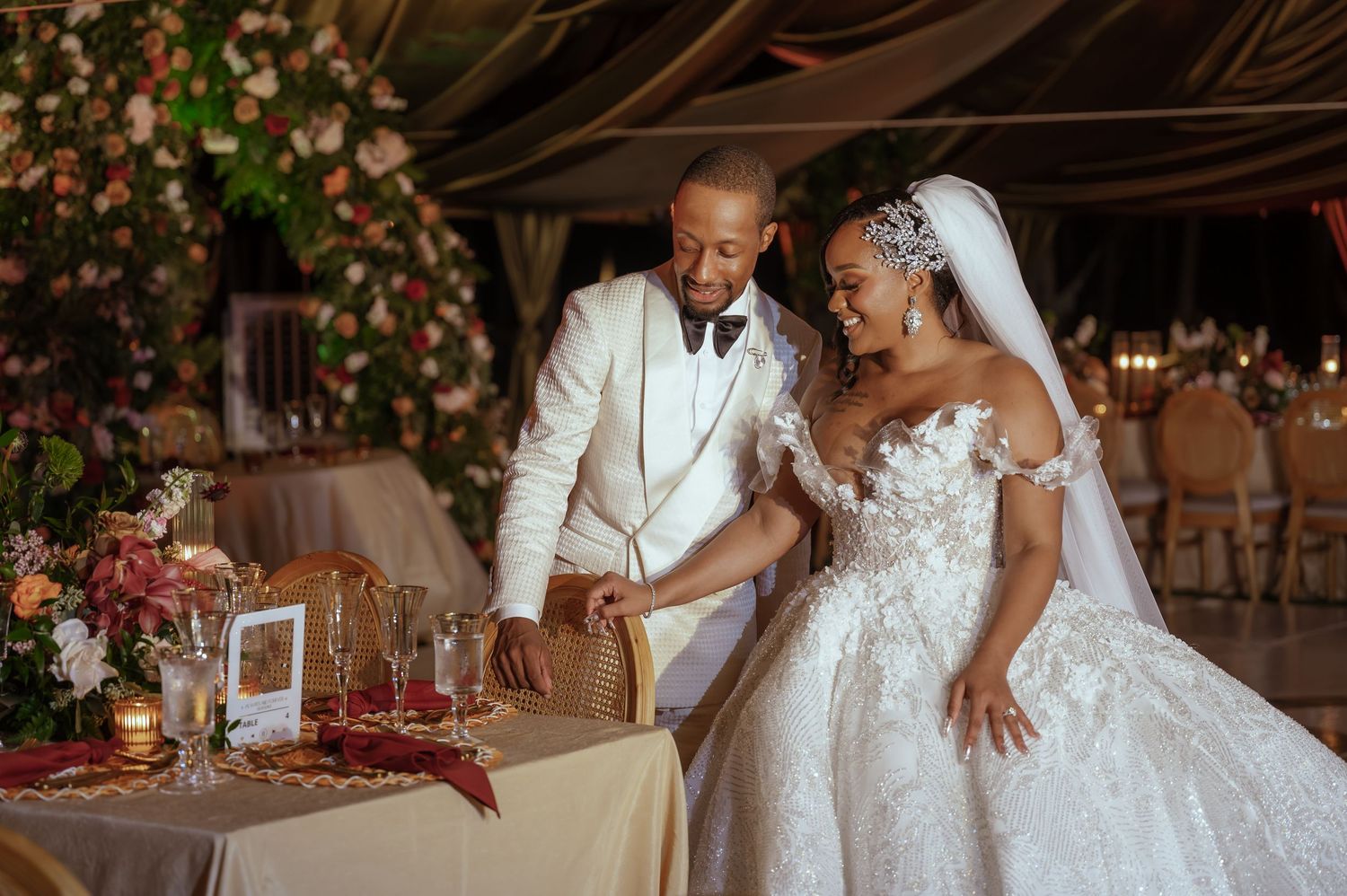 Wedding reception venue decorated with romantic lighting and floral arrangements.