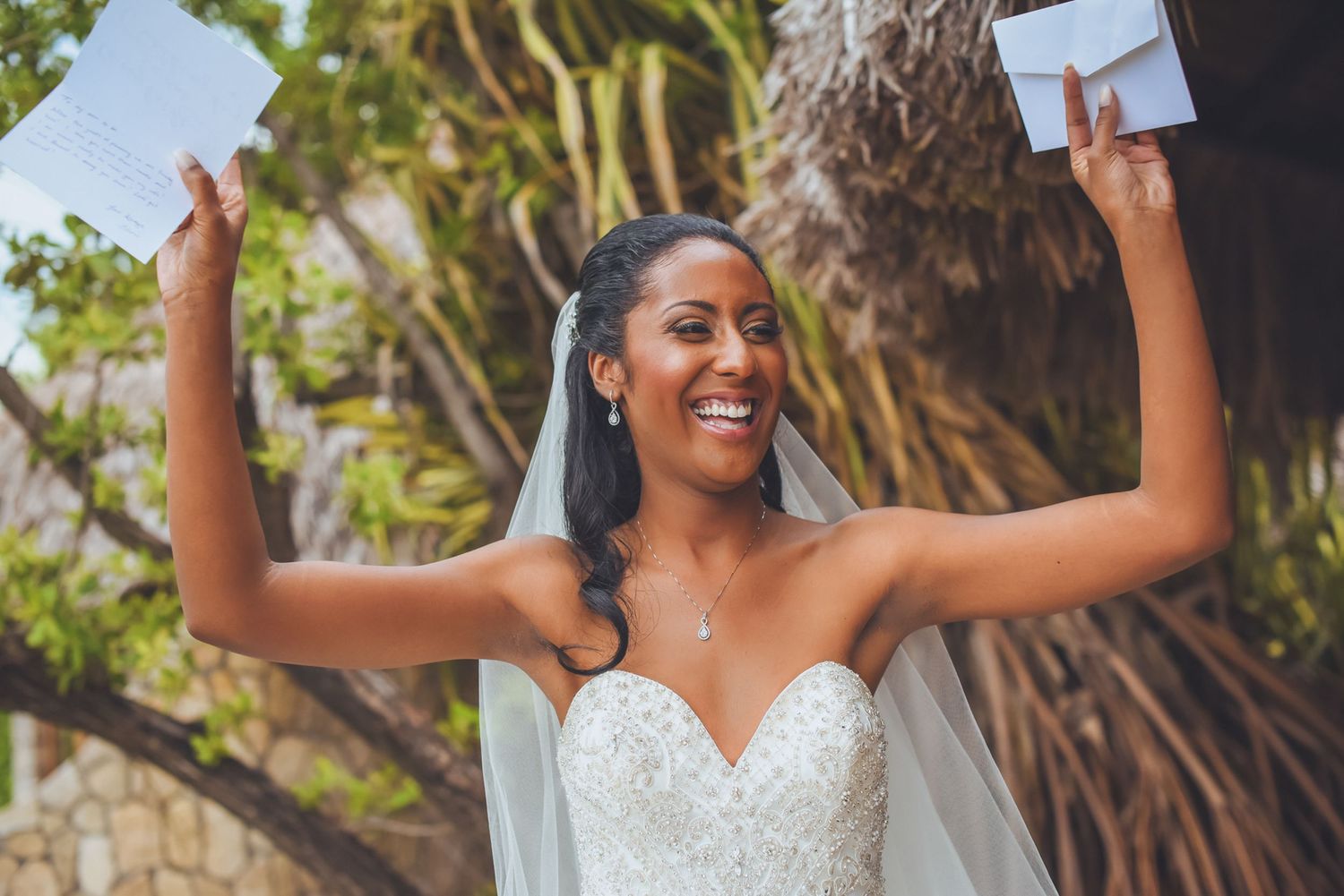 Bride shows excitement while reading messages during wedding preparations.
