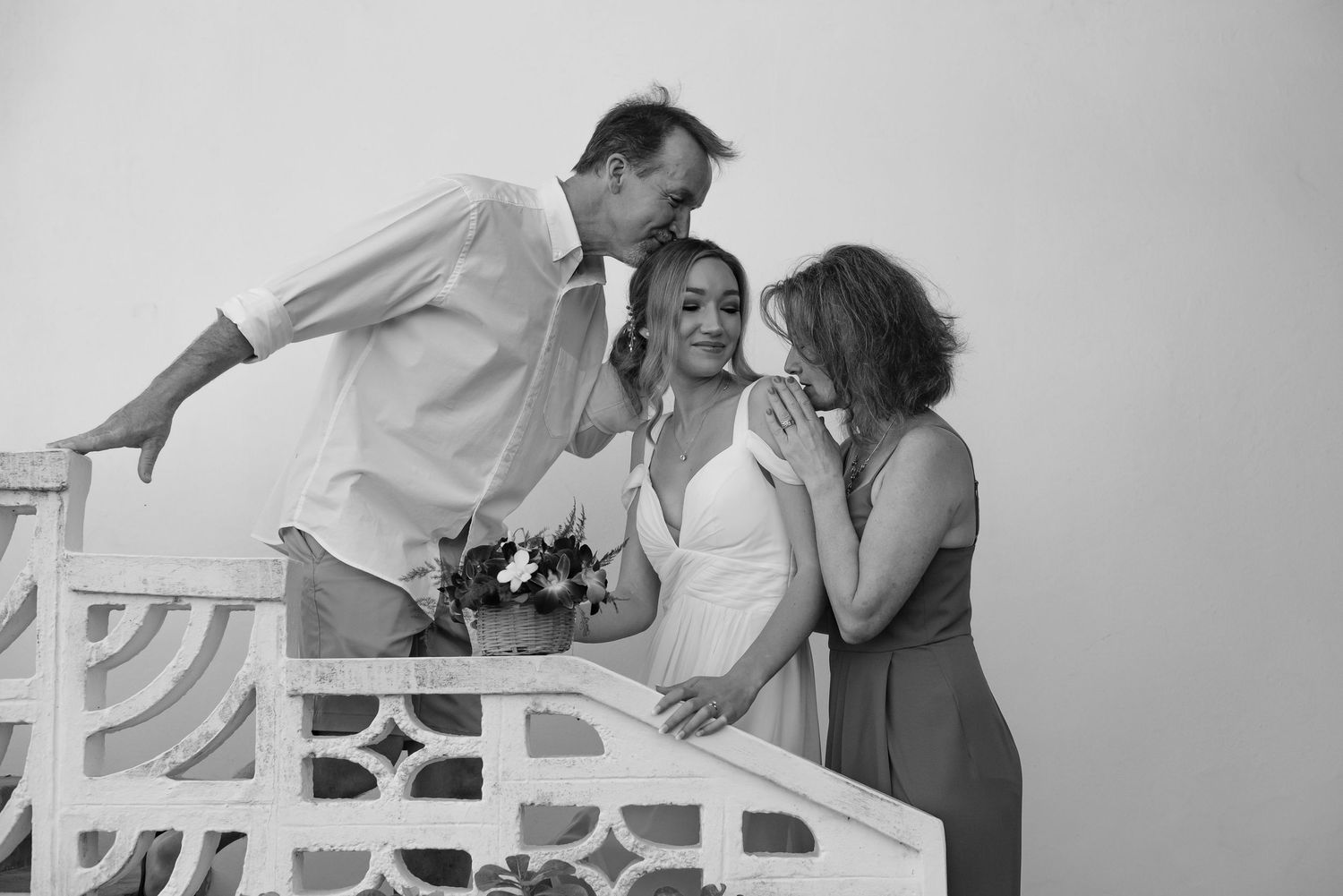 Black and white romantic wedding photos captured on decorative white furniture.