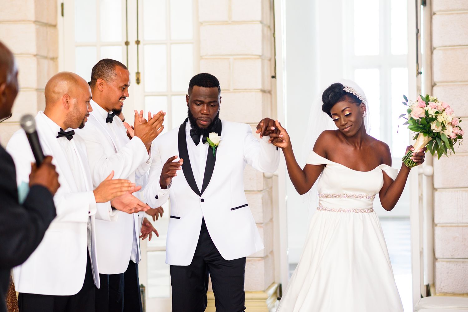 Wedding party members share candid moments in formal attire.