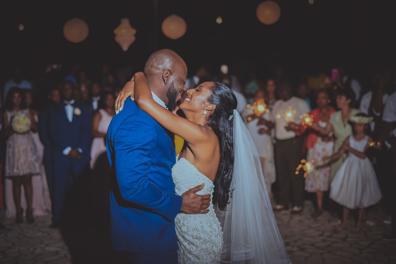 Evening wedding reception with paper lanterns and romantic lighting.