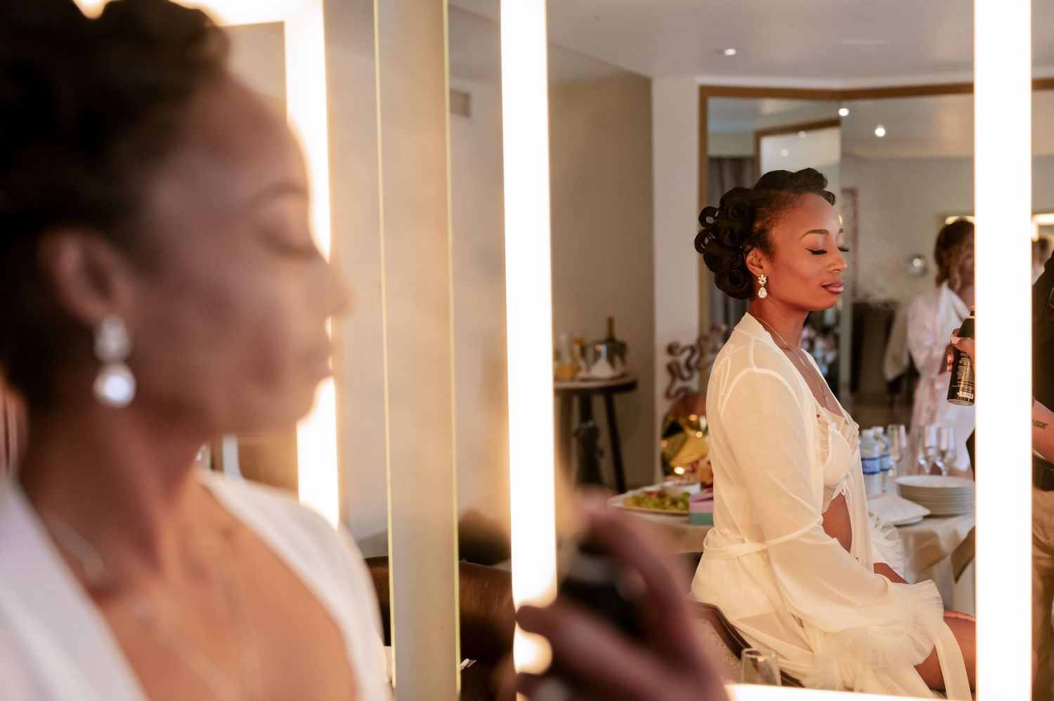 Reflective mirror scene showing elegant wedding preparation with warm lighting.