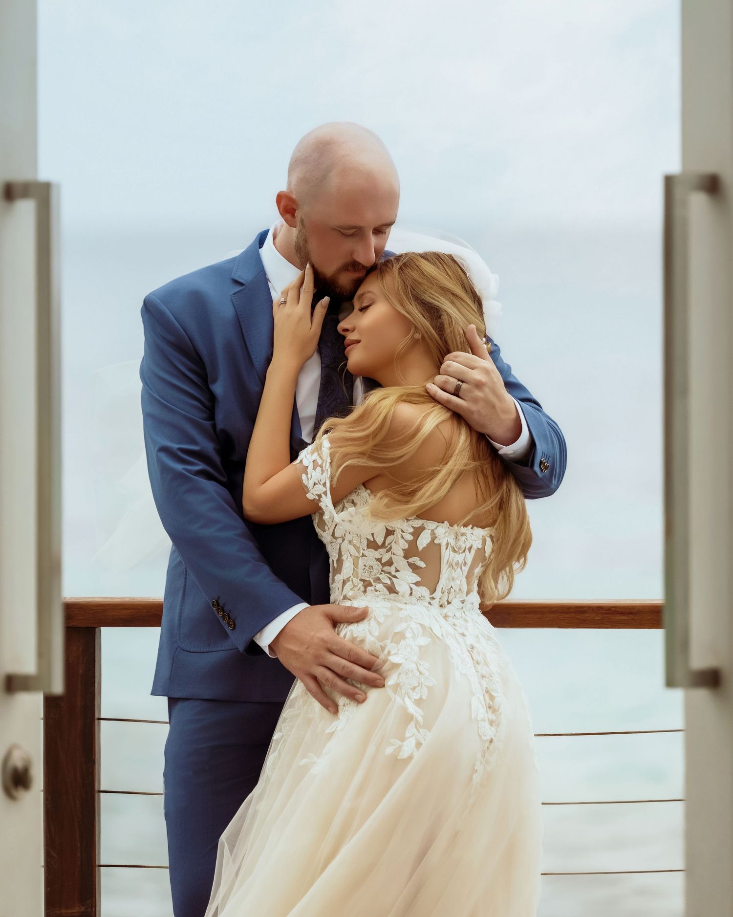 Intimate wedding moments captured against bright interior with ocean view windows.