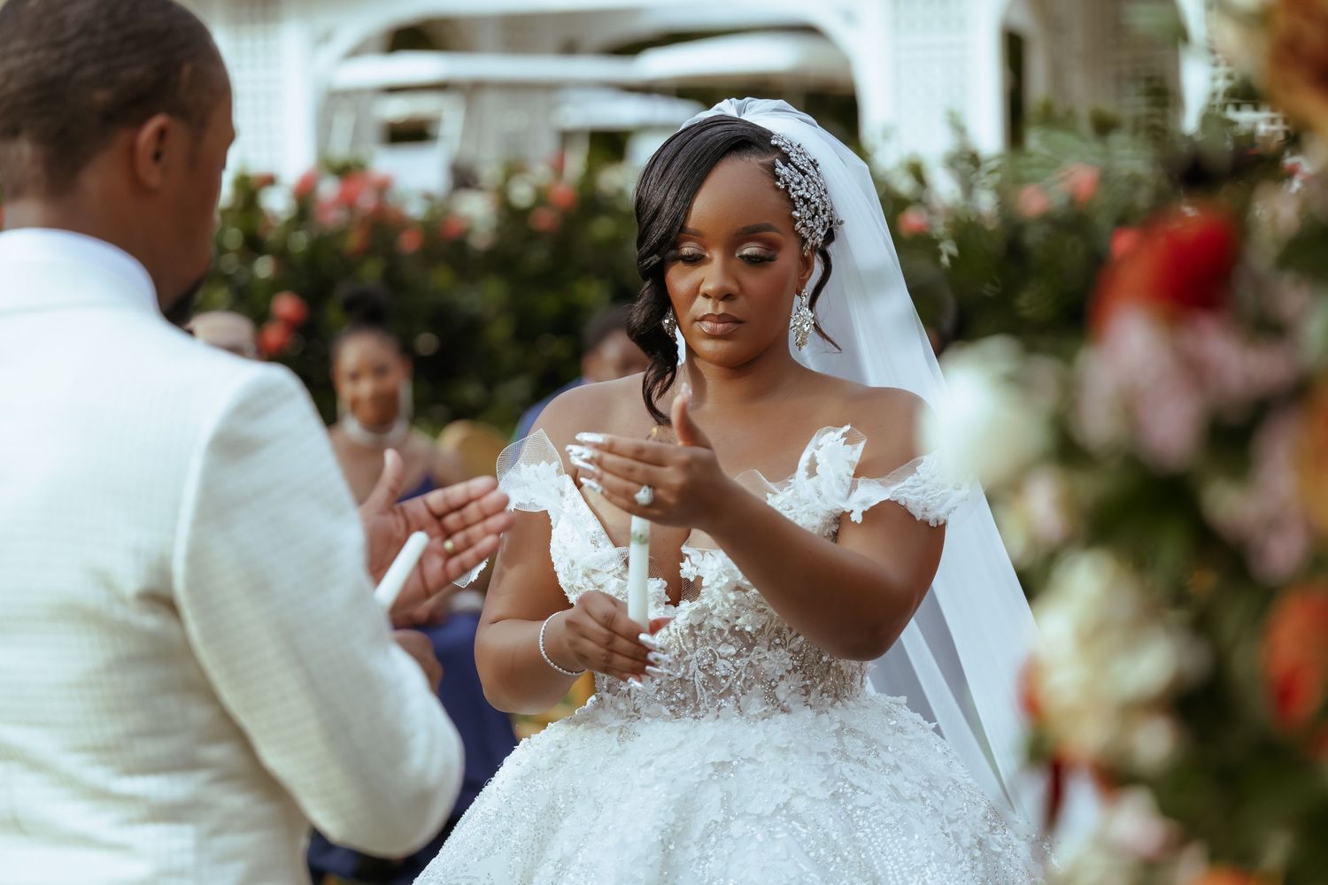 Bride in elegant lace wedding dress during outdoor portrait session.