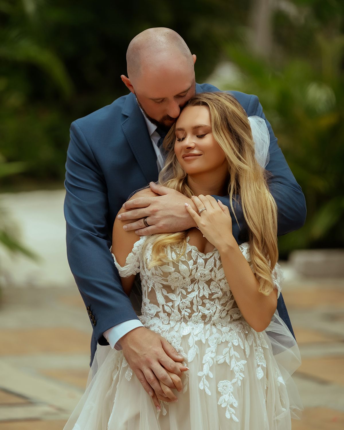 Romantic wedding portraits showing intimate moments between newlyweds in a garden setting.