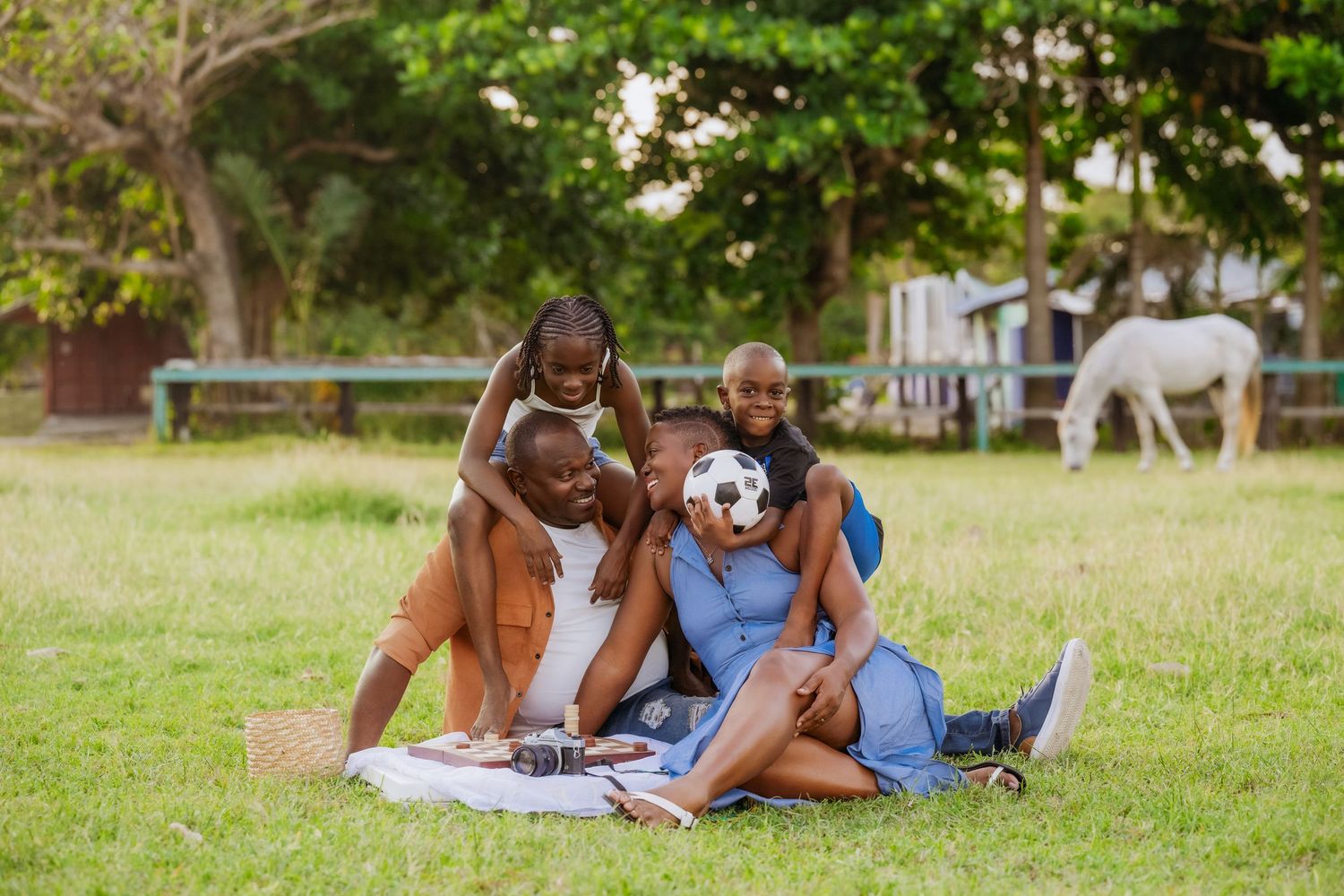 Couple relaxing together on grass during an outdoor photoshoot.