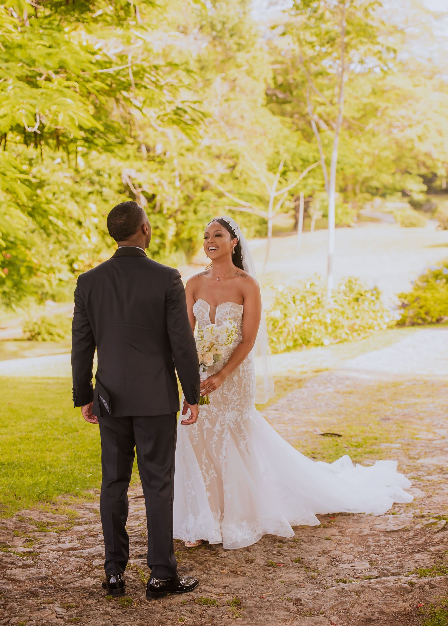 Wedding couple walking together during their first look moment in a garden setting.