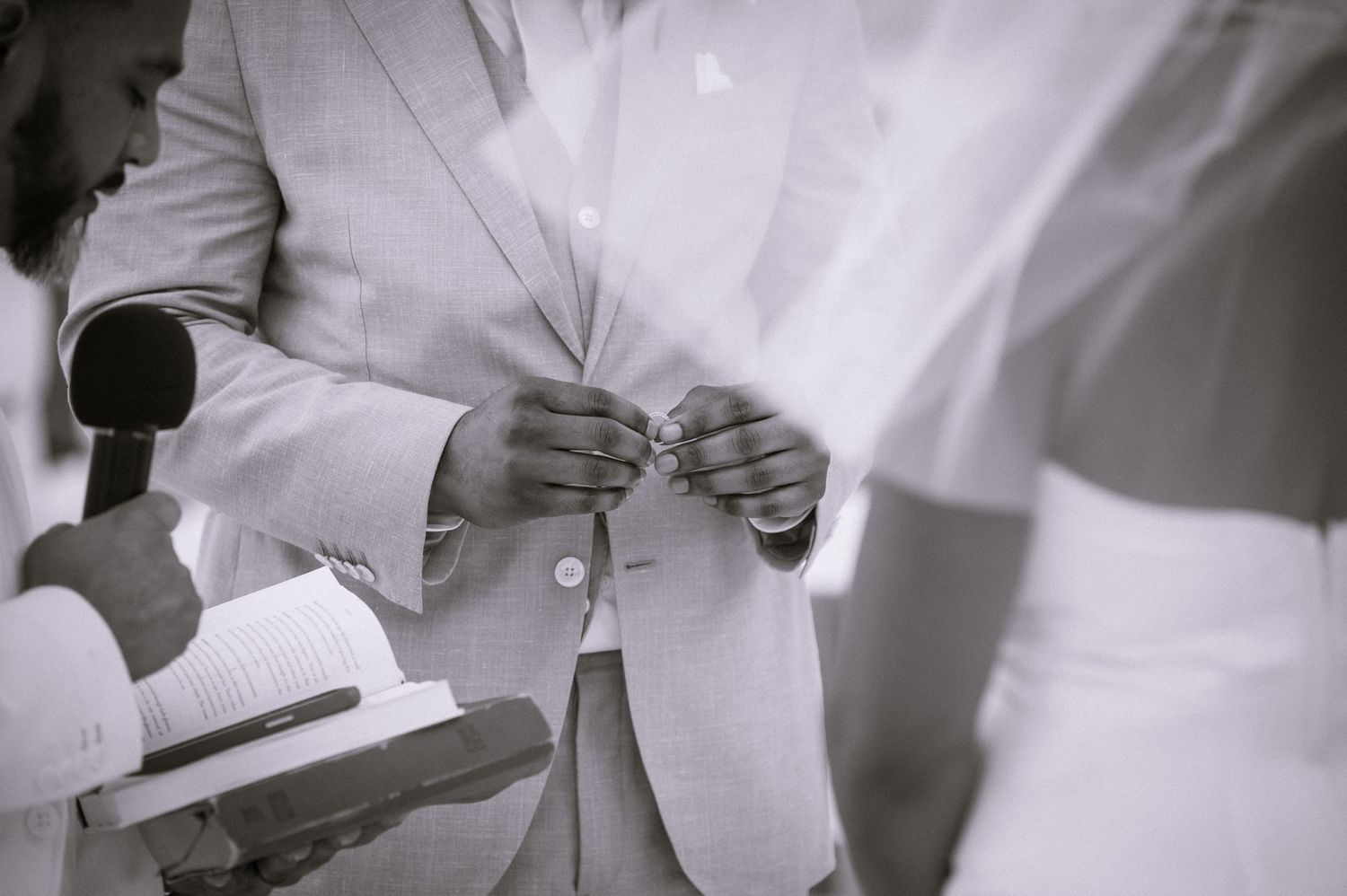 Black and white candid shot of wedding guests during a celebration.