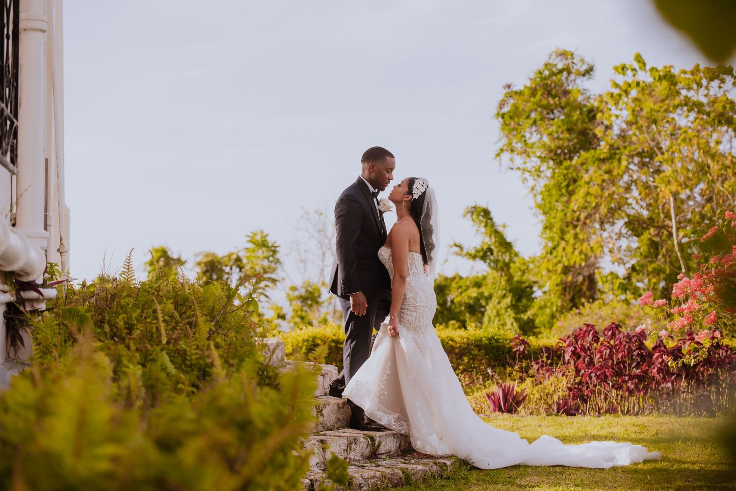 Wedding ceremony setting with floral arrangements and natural garden backdrop.