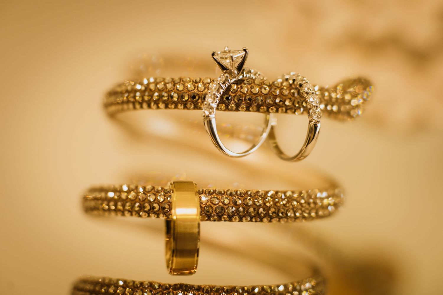 Close-up details of sparkling gold wedding jewelry and accessories.