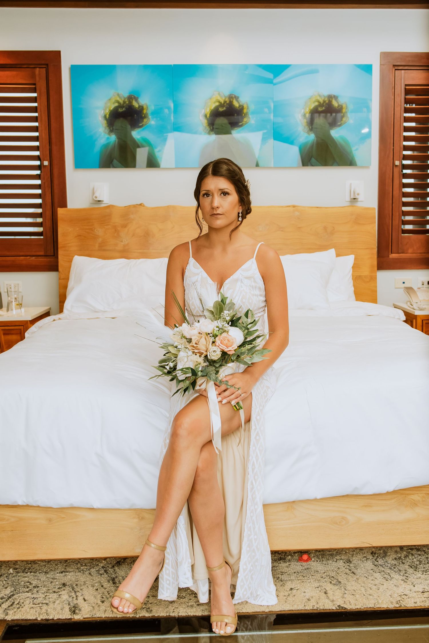 Elegant bridal portrait showing white dress details and floral bouquet against a coastal backdrop.