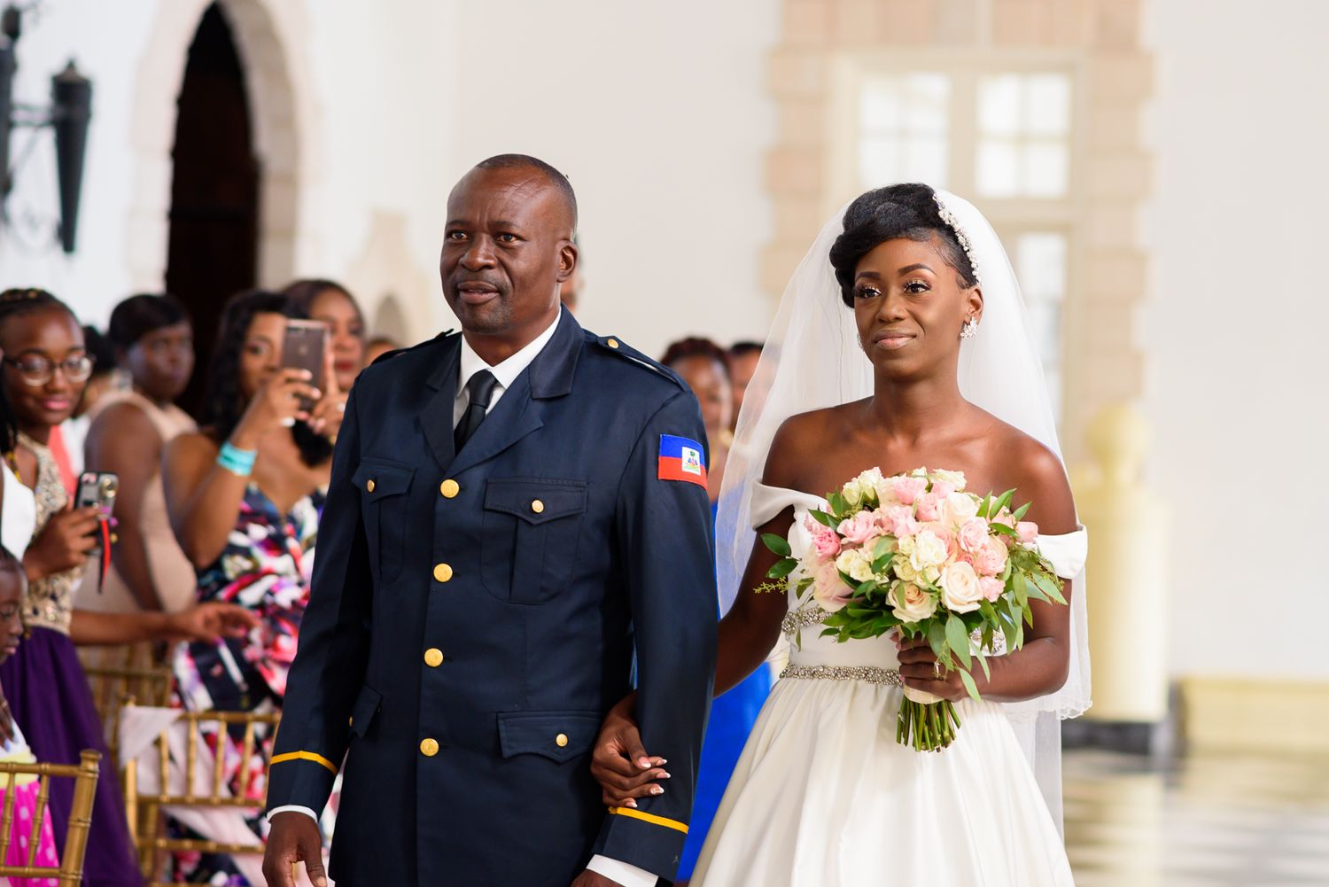 Wedding ceremony procession in a formal venue with classic architecture.