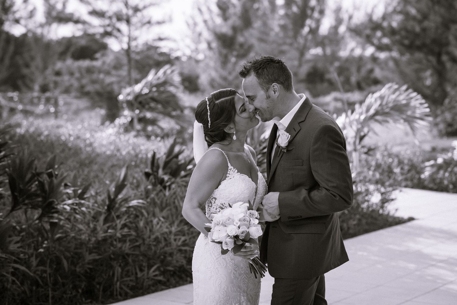 Black and white wedding portraits showing intimate moments in garden setting.