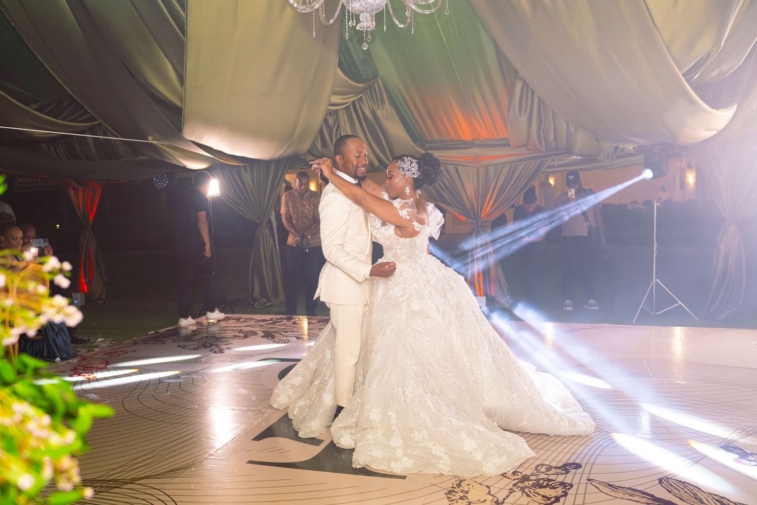 Dramatic nighttime wedding dance scene with spotlights and flowing white dress.