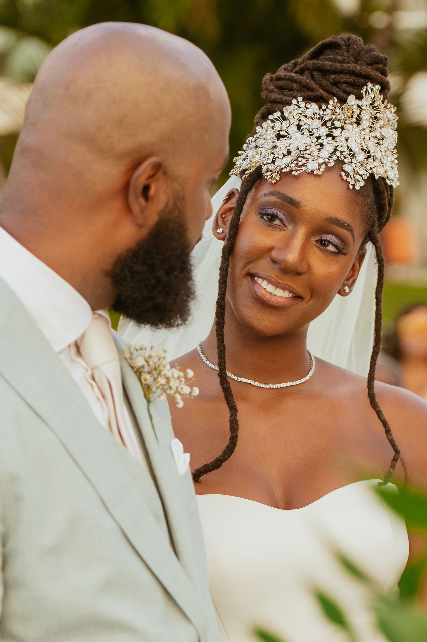 Close-up wedding portrait showing elegant bridal jewelry and accessories.